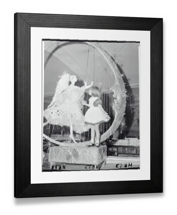 Framed Print : Girl Looking at Christmas Display with Angel Framed Print : Girl Looking at Christmas Display with Angel