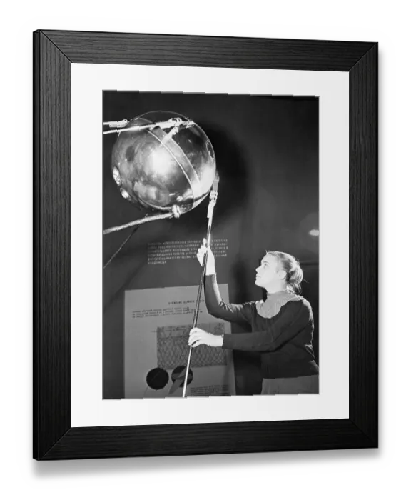 Framed Print : Guide Displays Model of Sputnik I