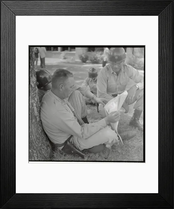 Framed Print : Soldier Sitting on Ground with Newspaper Framed Print : Soldier Sitting on Ground with Newspaper