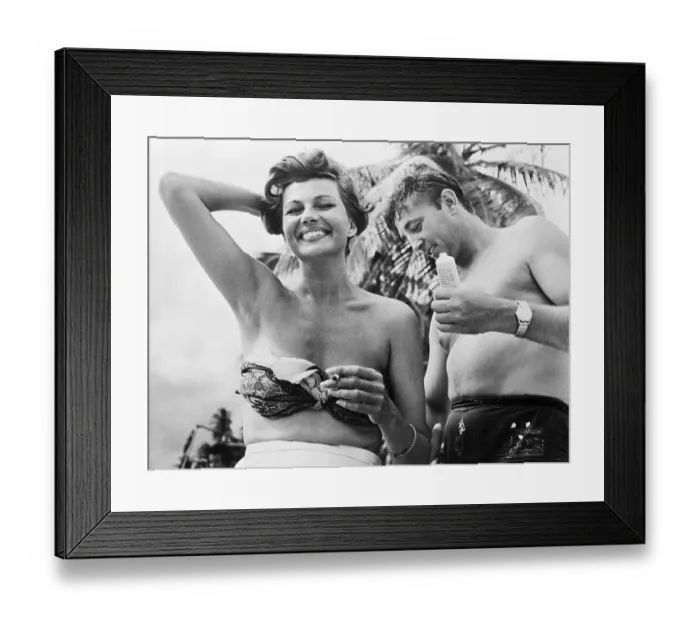 Framed Print : Robert Mitchum Putting Suntan Lotion on Rita Hayworth Framed Print : Robert Mitchum Putting Suntan Lotion on Rita Hayworth