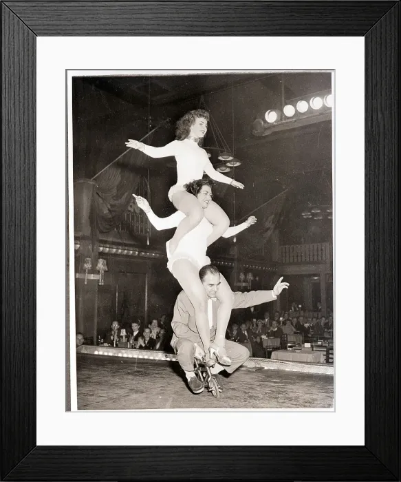Framed Print : Acrobats Balance on Miniature Bike Framed Print : Acrobats Balance on Miniature Bike