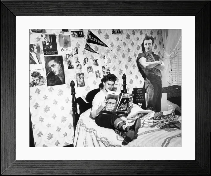Framed Print : James Dean Fan Reading Magazines on Bed