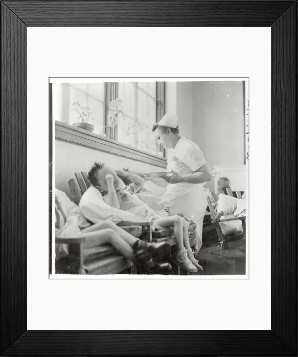 Framed Print : Nurse Feeding a Retarded Village Children Framed Print : Nurse Feeding a Retarded Village Children