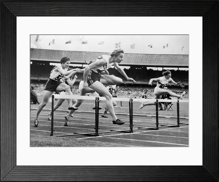 Framed Print : Woman Jumping Over Hurdles Framed Print : Woman Jumping Over Hurdles