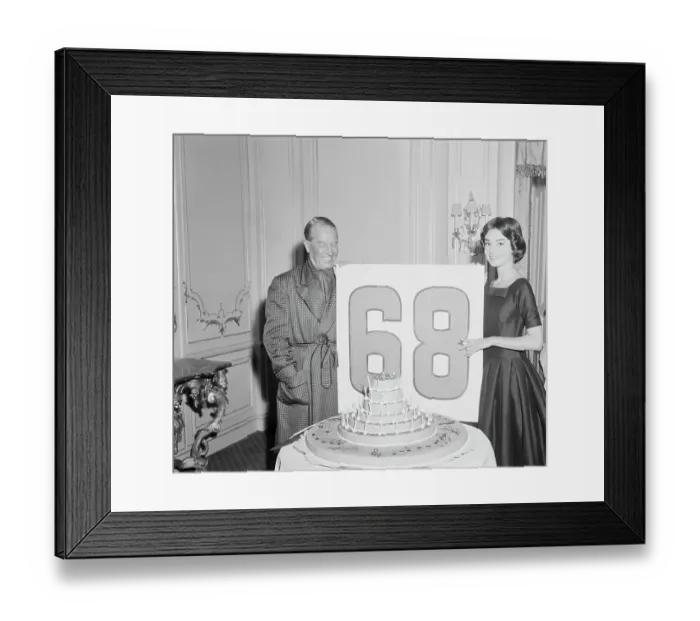 Framed Print : Audrey Hepburn Holding a Sign with Maurice Chevalier Framed Print : Audrey Hepburn Holding a Sign with Maurice Chevalier