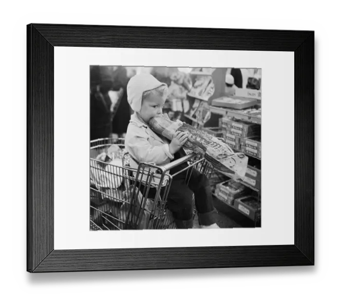 Framed Print : Child Eating a Loaf of Bread