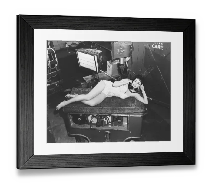 Framed Print : Joan Collins Reclines on Film Equipment Framed Print : Joan Collins Reclines on Film Equipment