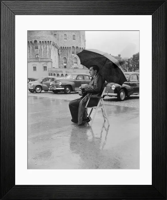 Framed Print : Photographer Sitting Under Umbrella Framed Print : Photographer Sitting Under Umbrella