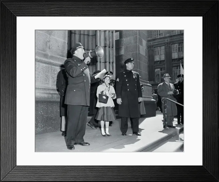 Framed Print : Policeman with megaphone and lost girl (13-15 years) during Easter Parade, Fifth Avenue, New York City, New York State, USA. April 01, 1956