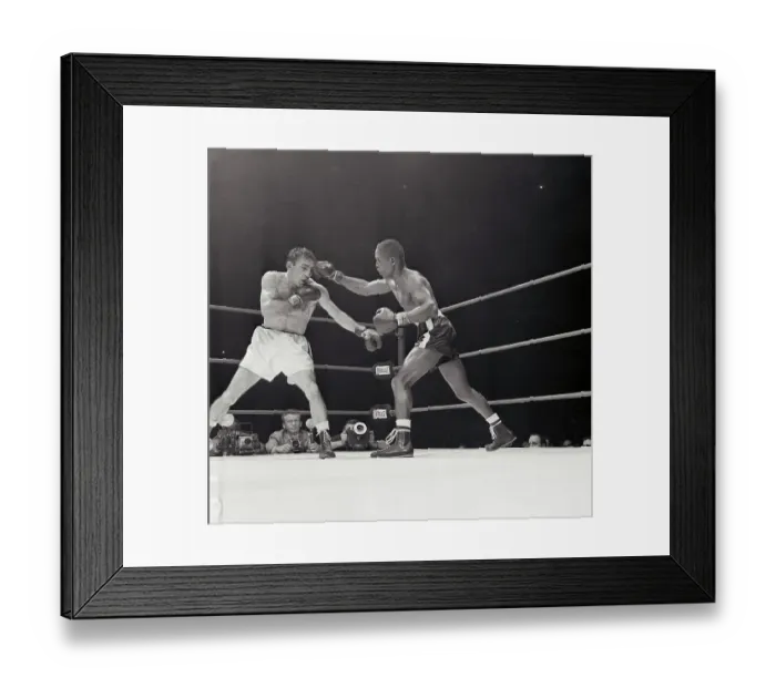 Framed Print : Challenger Johnny Saxton Attacks defending welterweight champion Carmen Basilio, left, during 9th round their title bout at Chicago Stadium 3 / 14. Saxton took a 15 round decision and the crown from Basilio Framed Print : Challenger Johnny Saxton Attacks defending welterweight champion Carmen Basilio, left, during 9th round their title bout at Chicago Stadium 3 / 14. Saxton took a 15 round decision and the crown from Basilio