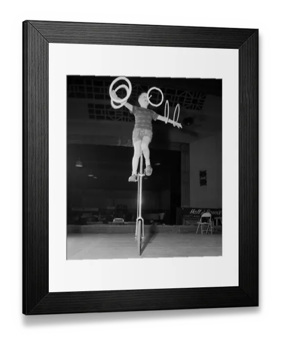 Framed Print : Ervine Hall Riding Unicycle While Juggling Hoops Framed Print : Ervine Hall Riding Unicycle While Juggling Hoops