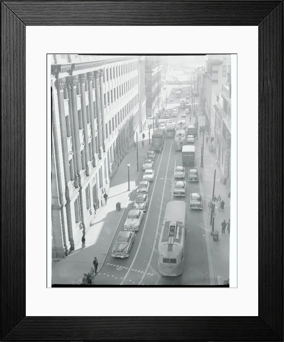 Framed Print : Busses and Cars Driving Down a City Street Framed Print : Busses and Cars Driving Down a City Street