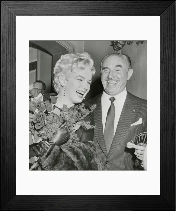 Framed Print : Marilyn Monroe Receiving Flowers From Jack Warner