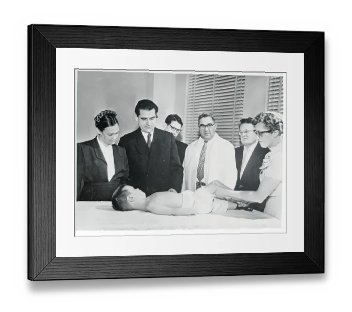 Framed Print : Medical Specialist Observing Young Polio Victim on Table Framed Print : Medical Specialist Observing Young Polio Victim on Table
