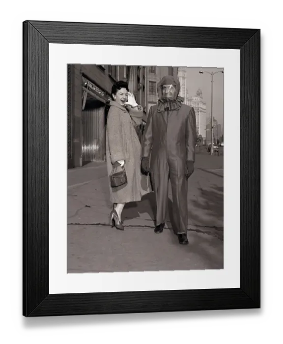 Framed Print : Man in Atomic-Shelter Suit with Woman Laughing Framed Print : Man in Atomic-Shelter Suit with Woman Laughing