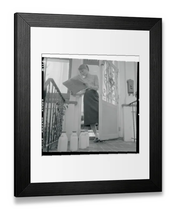 Framed Print : Carol Heiss Reading Newspaper and Standing in Her Doorway Framed Print : Carol Heiss Reading Newspaper and Standing in Her Doorway