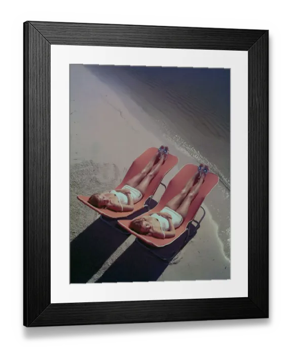 Framed Print : Two Young Women Lounging on the Beach Framed Print : Two Young Women Lounging on the Beach