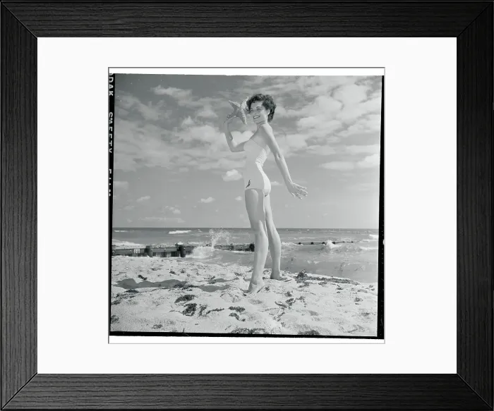 Framed Print : Profile of Young Woman Posing with Starfish in Hand Framed Print : Profile of Young Woman Posing with Starfish in Hand
