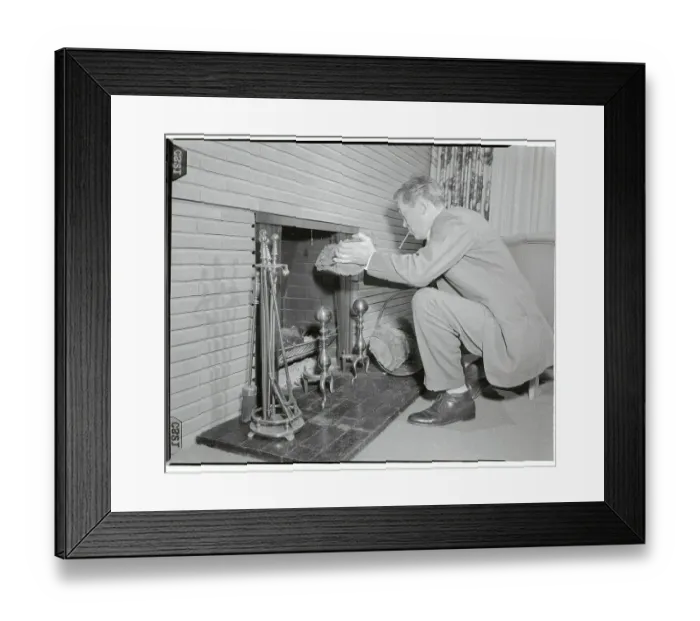 Framed Print : John Huston Throwing Log onto Fire Framed Print : John Huston Throwing Log onto Fire