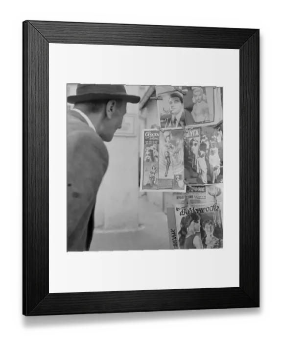 Framed Print : Man Looking at Magazine Covers Framed Print : Man Looking at Magazine Covers