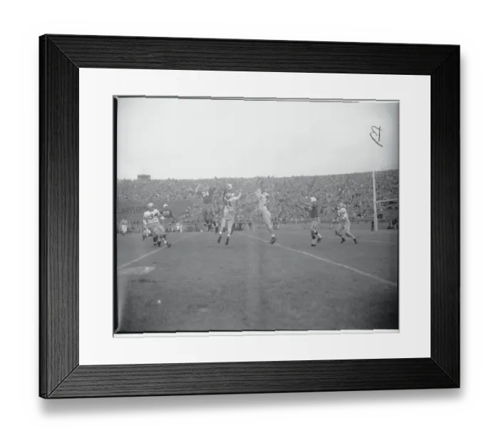 Framed Print : Football Players Leaping for a Pass Framed Print : Football Players Leaping for a Pass