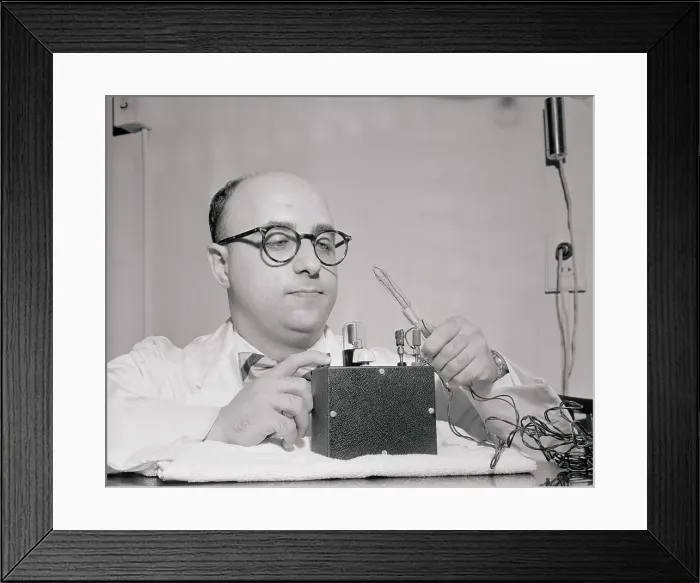 Framed Print : Scientist Demonstrating His Invention