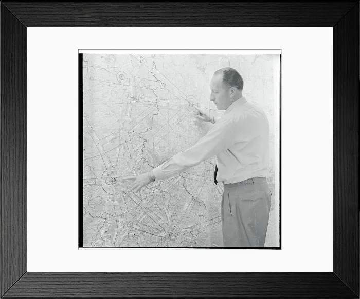 Framed Print : Airport Official Pointing to a Map Framed Print : Airport Official Pointing to a Map