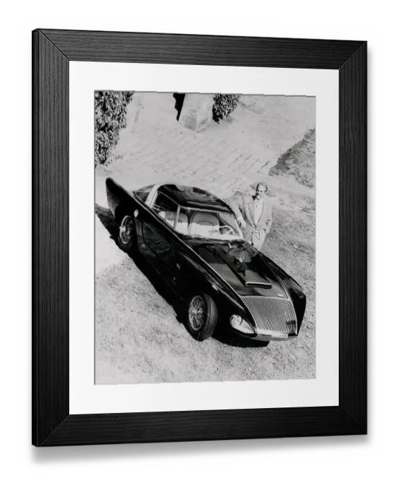 Framed Print : Raymond Loewy Posing Next to a Car Framed Print : Raymond Loewy Posing Next to a Car