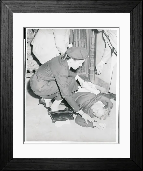 Framed Print : Policewoman Trying to Revive a Fainted Woman Framed Print : Policewoman Trying to Revive a Fainted Woman