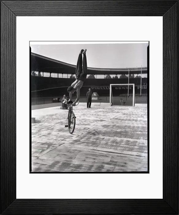 Framed Print : Man Riding Bicyce Doing Handstand Framed Print : Man Riding Bicyce Doing Handstand