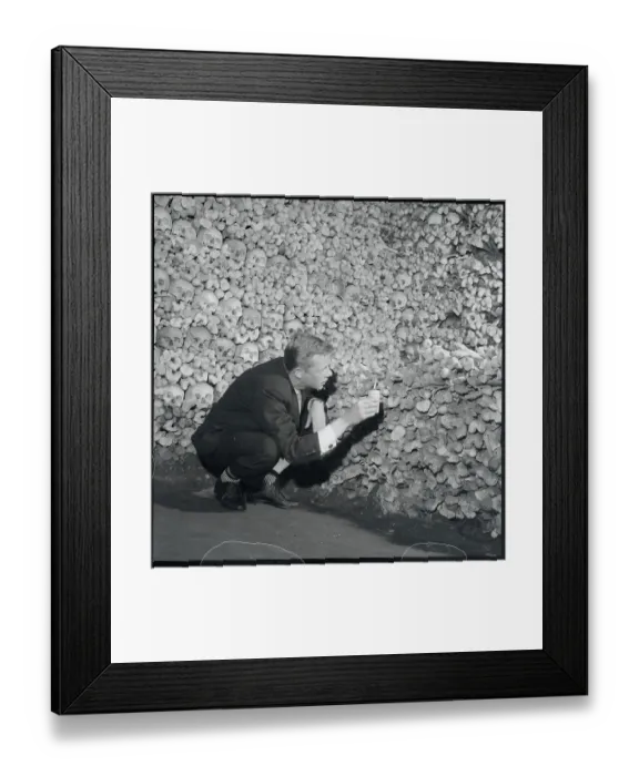 Framed Print : Man Examining Pile of Skeleton Remains Framed Print : Man Examining Pile of Skeleton Remains