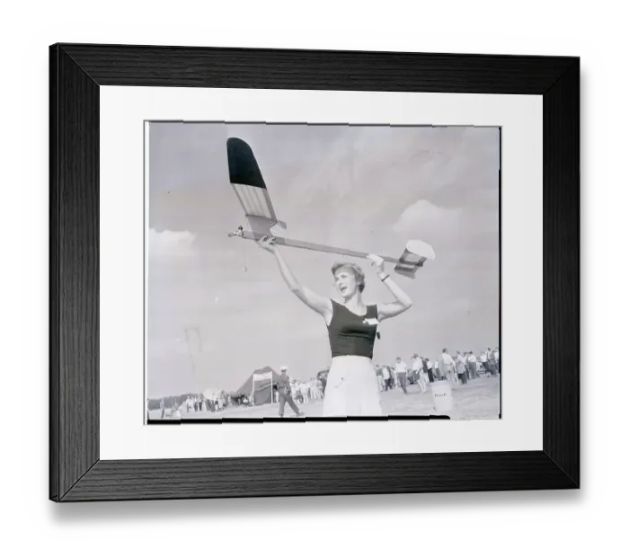 Framed Print : Woman Holding a Model Plane Framed Print : Woman Holding a Model Plane