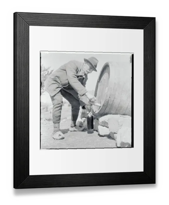 Framed Print : Elderly Man Draining Brew from Barrel Framed Print : Elderly Man Draining Brew from Barrel