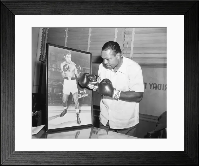 Framed Print : Archie Moore Punching at Picture of Rocky Marciano Framed Print : Archie Moore Punching at Picture of Rocky Marciano