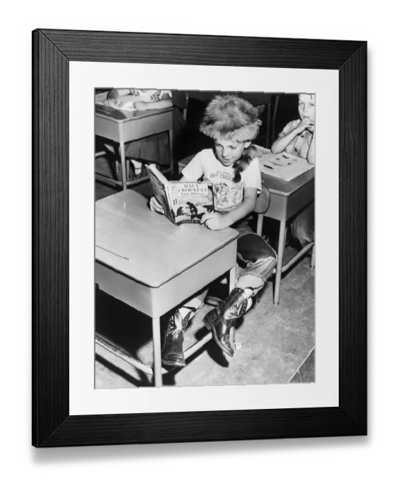 Framed Print : Child Reading about Davy Crockett Framed Print : Child Reading about Davy Crockett