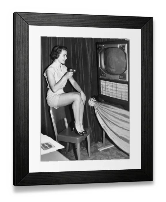 Framed Print : Woman Changes Tv Channels With Remote