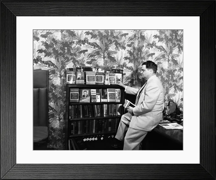 Framed Print : George Wilson Looks at Billy Graham's Book Framed Print : George Wilson Looks at Billy Graham's Book