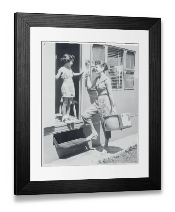 Framed Print : Woman Carrying a Portable Television Framed Print : Woman Carrying a Portable Television