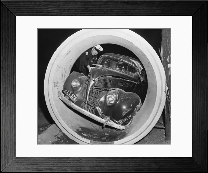 Framed Print : Police Officer Viewing Automobile Lodged In Drain Pipe Framed Print : Police Officer Viewing Automobile Lodged In Drain Pipe