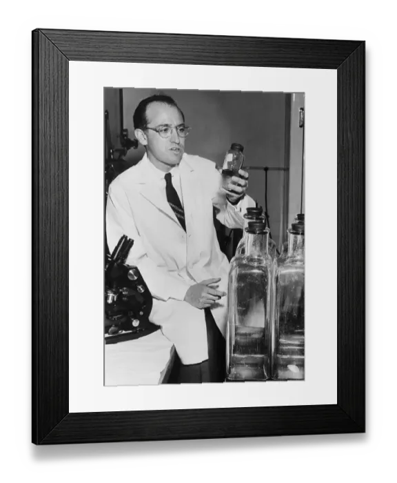 Framed Print : Jonas Salk Holding Bottle in Laboratory Framed Print : Jonas Salk Holding Bottle in Laboratory