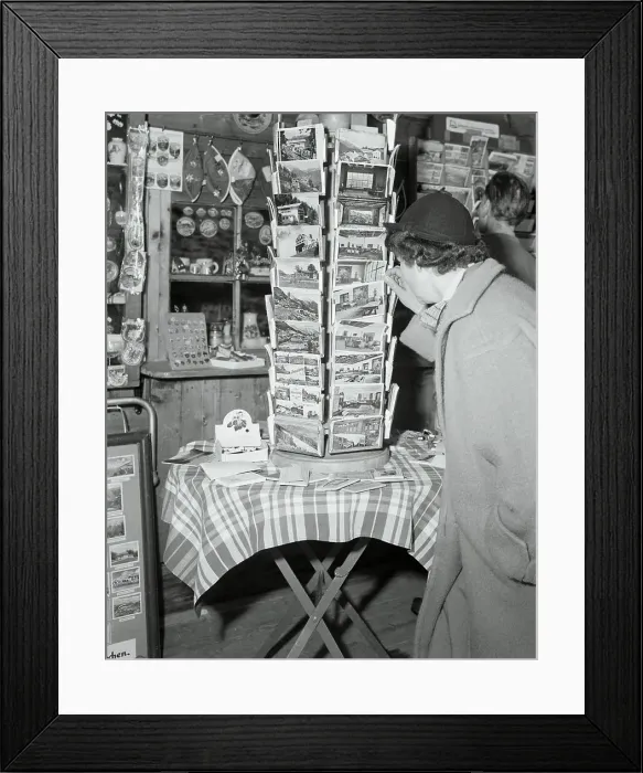 Framed Print : Potential Buyers Reading Postcard Display Framed Print : Potential Buyers Reading Postcard Display