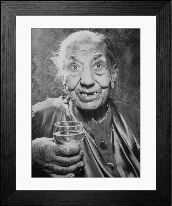 Framed Print : Elderly Woman Holding Glass of Liquor Framed Print : Elderly Woman Holding Glass of Liquor