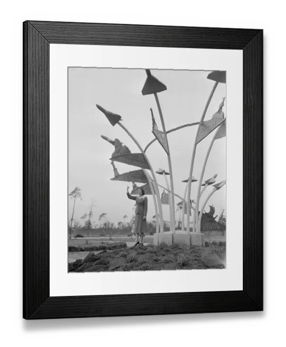 Framed Print : Stewardess Posing by Travel Indicator Framed Print : Stewardess Posing by Travel Indicator