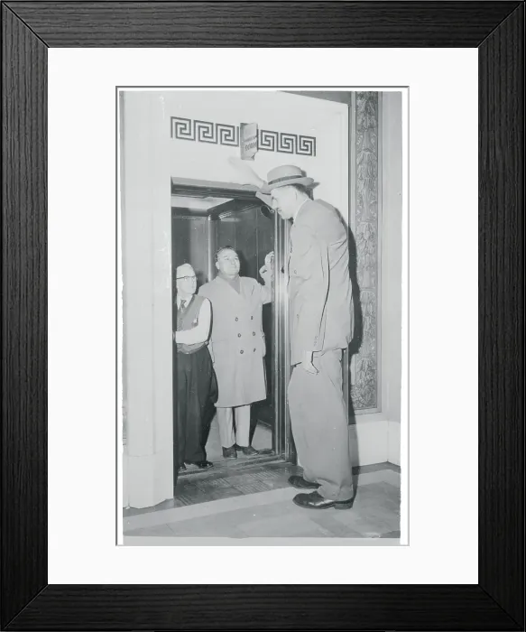 Framed Print : Tallest Man Entering Elevator Framed Print : Tallest Man Entering Elevator