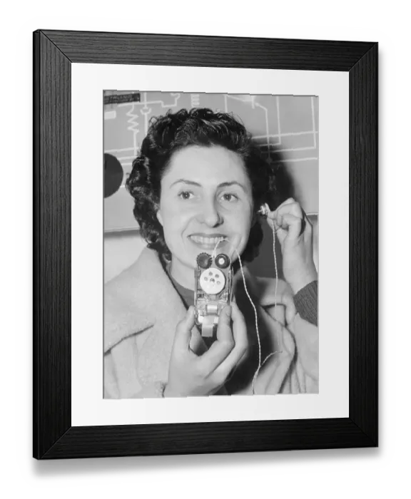 Framed Print : Woman Using Miniature Radio Receiver Framed Print : Woman Using Miniature Radio Receiver