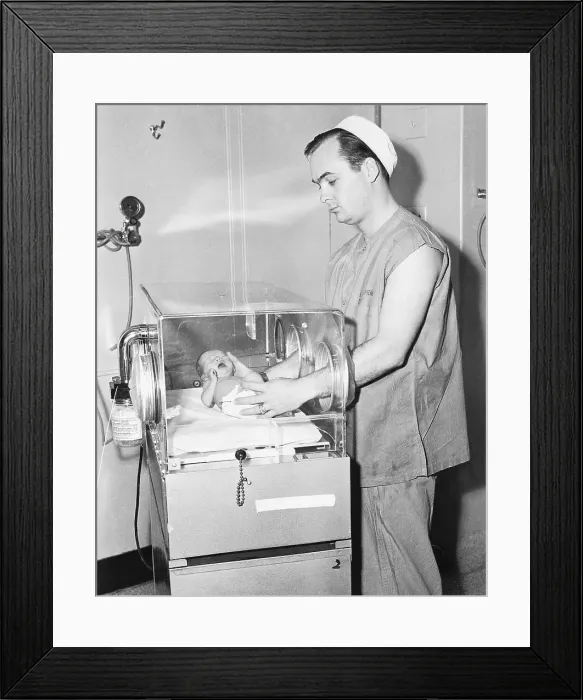 Framed Print : Corpsman Placing Baby into an Isolette