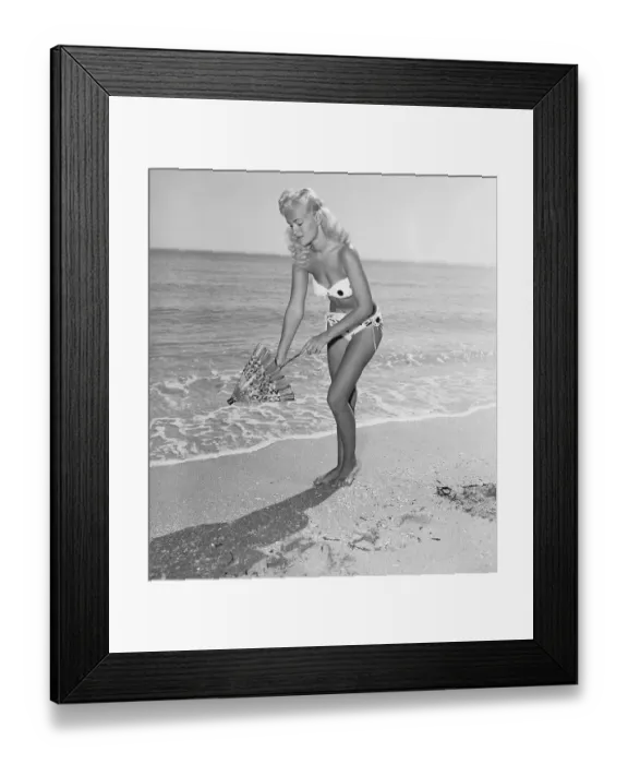 Framed Print : Woman Opening a Parasol on the Beach Framed Print : Woman Opening a Parasol on the Beach