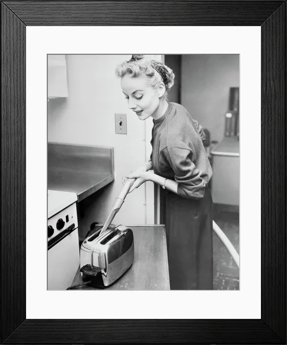 Framed Print : Woman Cleaning Toaster with Vacuum Cleaner Framed Print : Woman Cleaning Toaster with Vacuum Cleaner