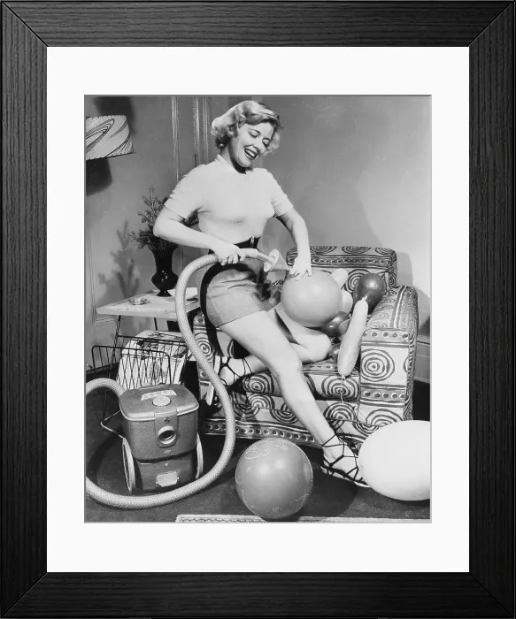 Framed Print : Woman Inflating Balloons with a Vacuum Cleaner Framed Print : Woman Inflating Balloons with a Vacuum Cleaner