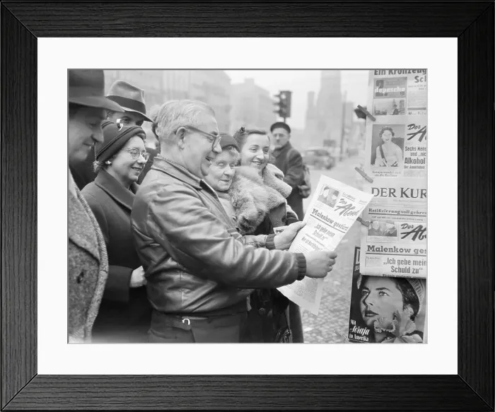 Framed Print : Group Reading Newspaper Framed Print : Group Reading Newspaper